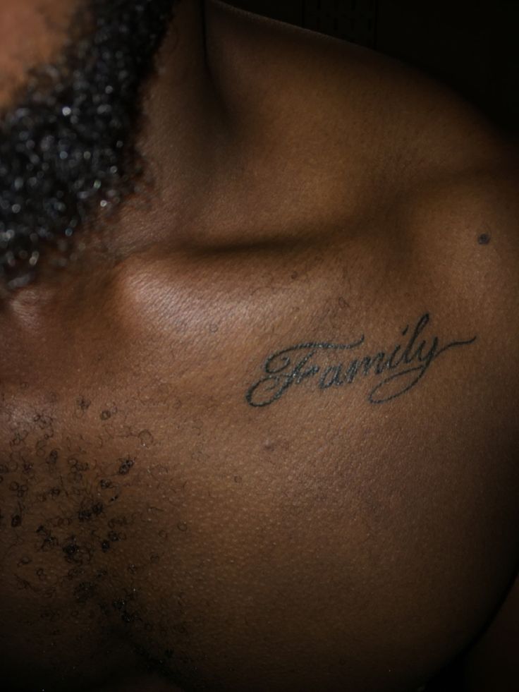 a close up of a man's chest with the word family written on it