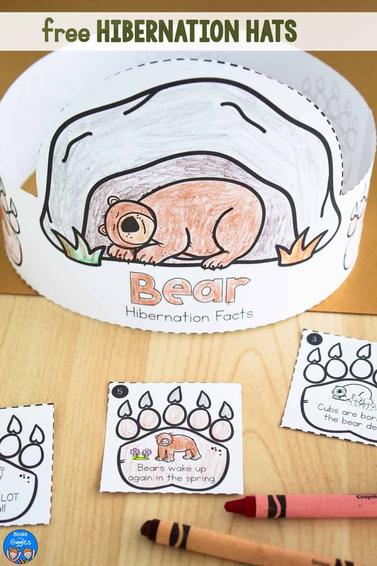 a paper hat with the word bear written on it and two crayons next to it