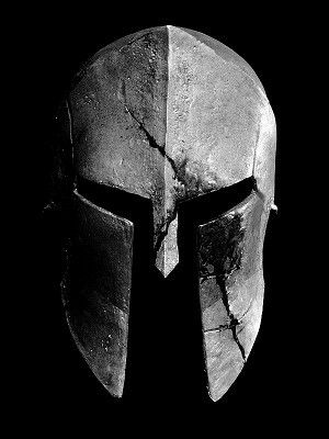 a black and white photo of a spartan's helmet on a dark background with the words gladia written below it