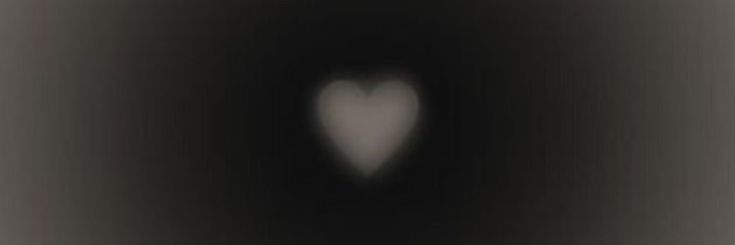 an abstract black and white photo with a heart shaped object in the middle of it