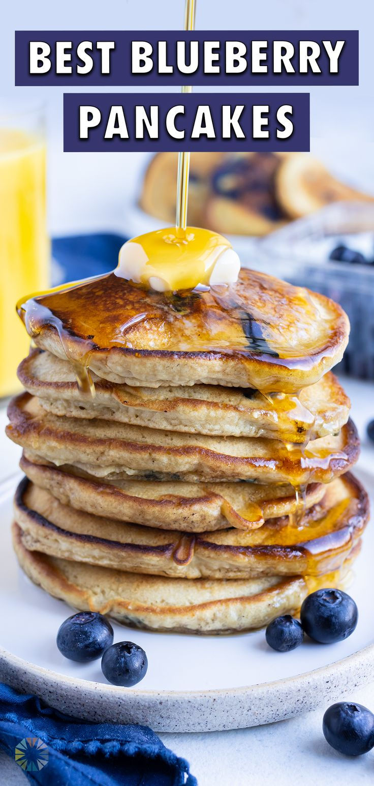 blueberry pancakes on a plate with syrup and fresh blueberries in the background text reads best blueberry pancakes