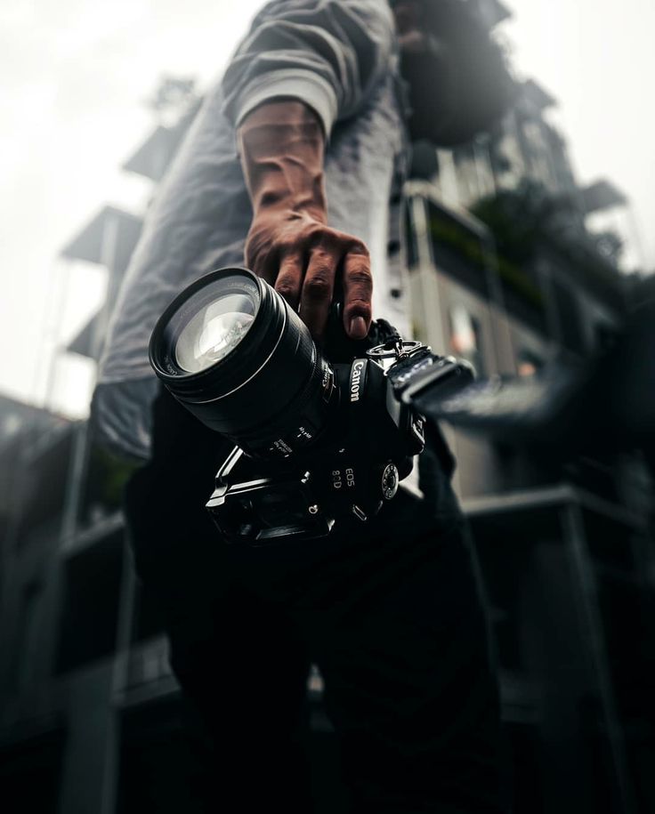 a man holding a camera with his hand