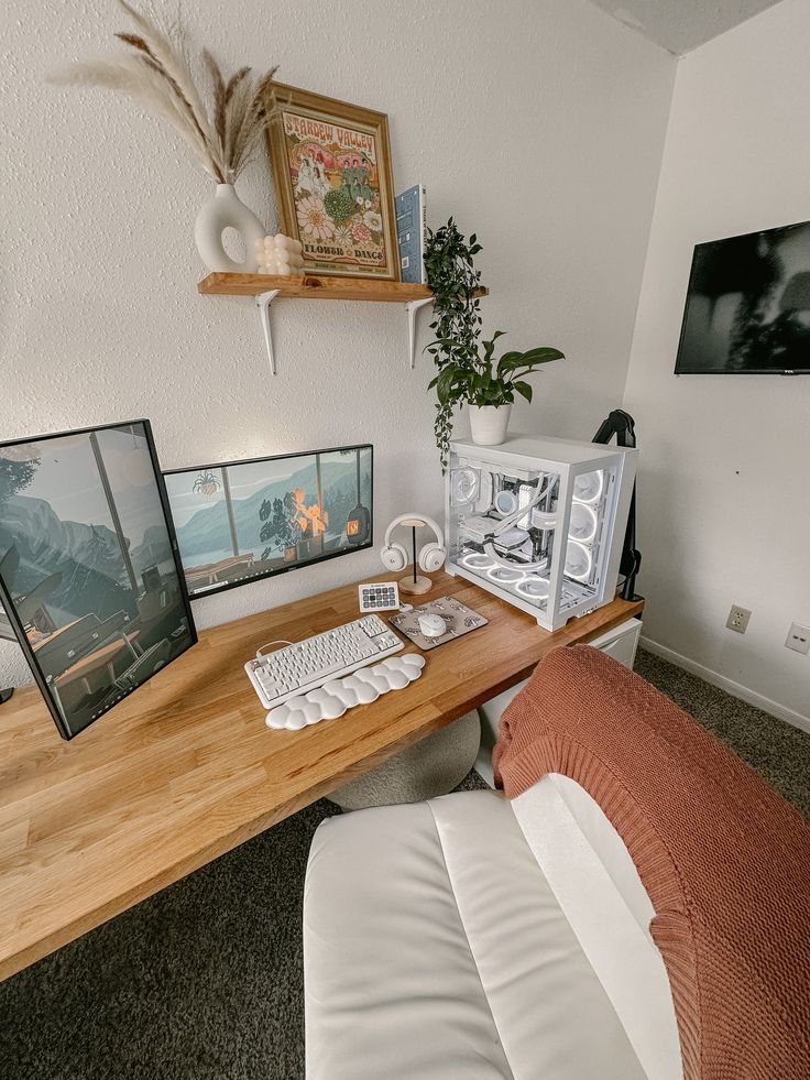 there is a desk with two pictures on the wall and a keyboard in front of it