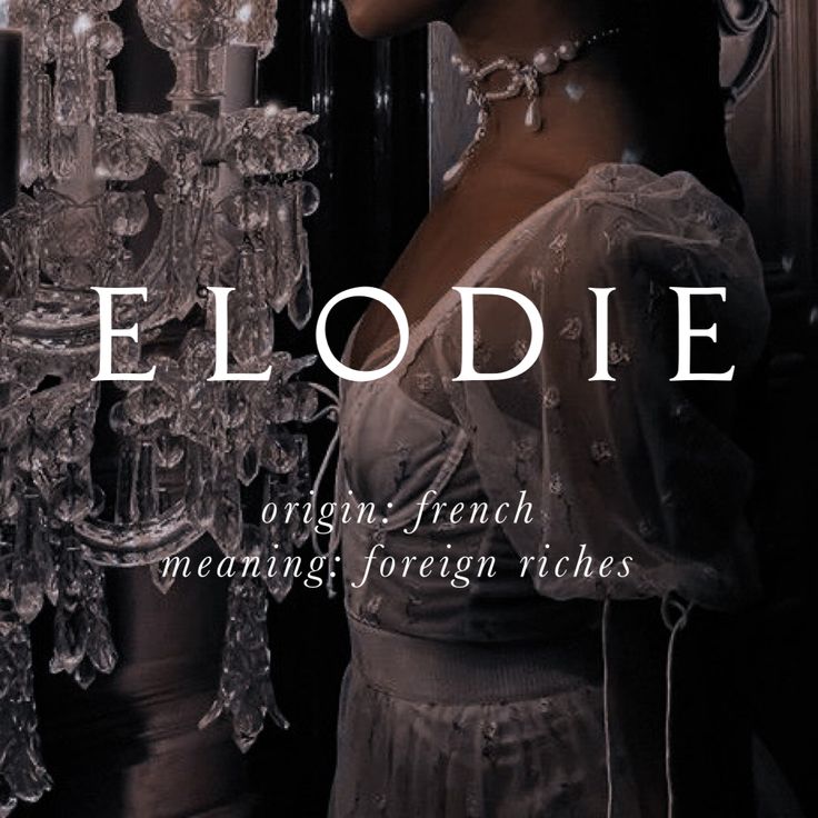 a woman standing in front of a chandelier with the words flodie written on it