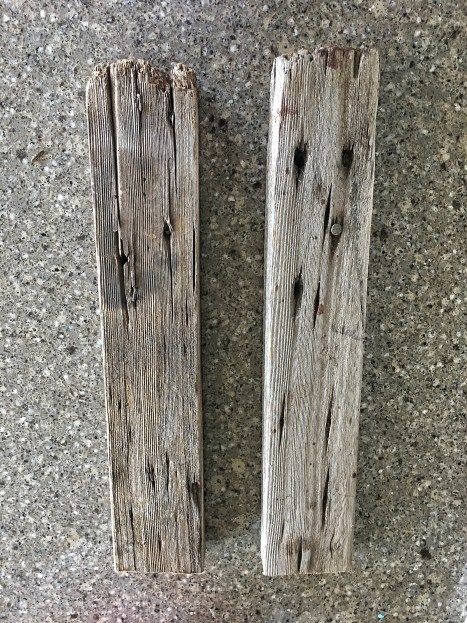 two pieces of wood sitting on the ground