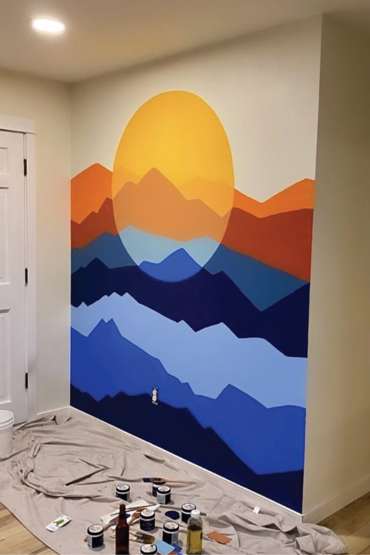 a painting is being painted on the wall in an empty room