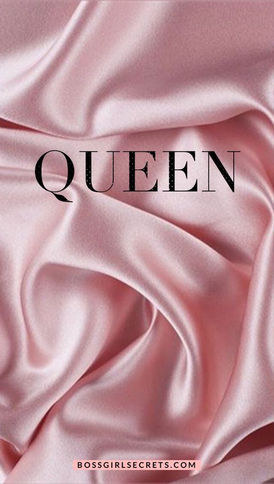 a pink satin fabric with the word queen in black on it's bottom corner