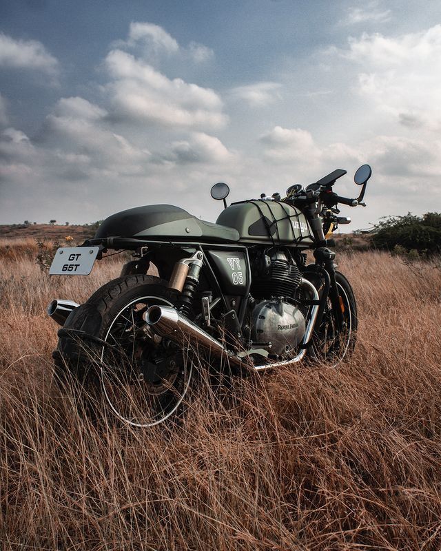 a motorcycle is parked in the tall grass