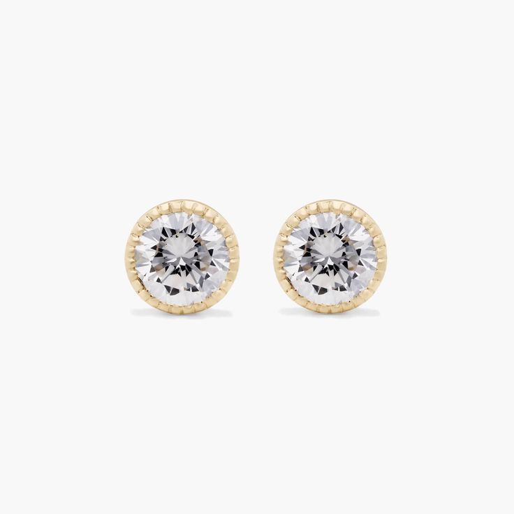 14K Yellow Gold Milgrain Bezel Lab-Grown Diamond Stud Earrings (0.25 CTW - F-G / VS2-SI1). This design is the perfect mix of modern and vintage design, crafted to accent the beauty of the round brilliant lab created diamonds with a milgrain bezel and rolled wire basket. This earring will fit slightly off the ear and features friction backs. Everyday Luxury Round Halo Earrings, Gold Earrings With Bezel Setting In Timeless Style, Gold Earrings With Bezel Setting Timeless Style, Timeless Yellow Gold Earrings With Bezel Setting, Timeless Gold Earrings With Bezel Setting, Luxury Formal Earrings With Bezel Setting, Timeless Anniversary Earrings With Bezel Setting, Timeless Bezel Set Earrings For Anniversary, Timeless Round Earrings With Bezel Setting