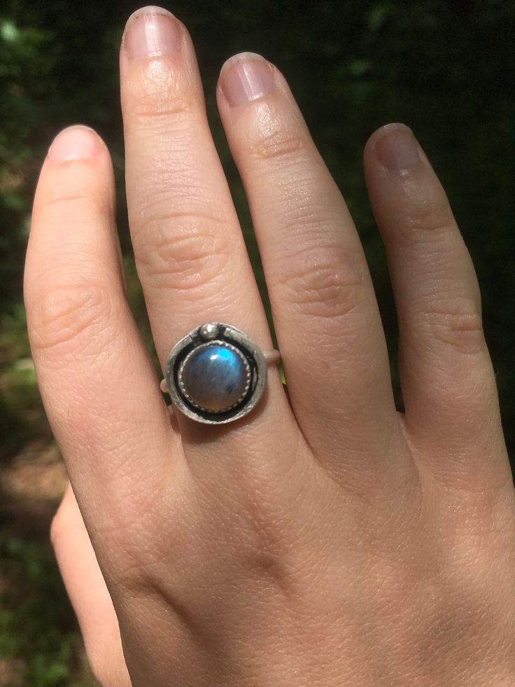 This simple ring is so light and airy, you're sure to receive compliments whenever you wear it. It features a hollowed back plate in order for the stone to be most responsive to light, and loves to throw reflections of light aqua, lilac, and other tiny spectrums of color when it hits the light. This ring is handcrafted from sterling silver and is super comfortable. Adjustable Labradorite Rings For Anniversary, Adjustable Moonstone Ring For Everyday, Adjustable Everyday Moonstone Ring, Unique Adjustable Ring With Round Stone, Unique Adjustable Rings With Round Stone, Unique Turquoise Moonstone Ring, Minimalist Silver Turquoise Ring, Unique Labradorite Promise Ring, Adjustable Labradorite Moonstone Promise Ring