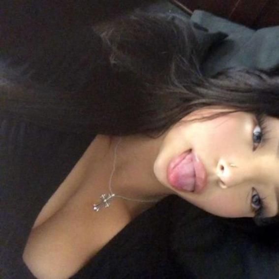 a woman with her tongue out laying down