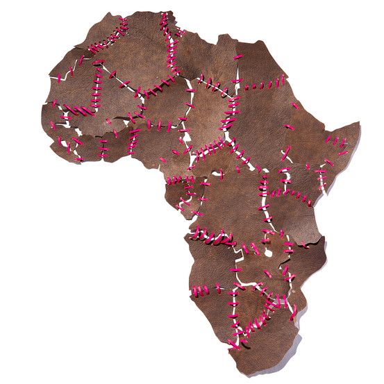 a map made out of brown paper with pink string and beads on it's side