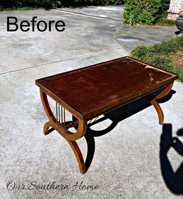 a wooden table sitting on top of a cement floor next to a sidewalk with the words before and after