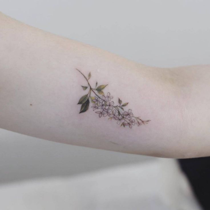 a woman's arm with flowers on it