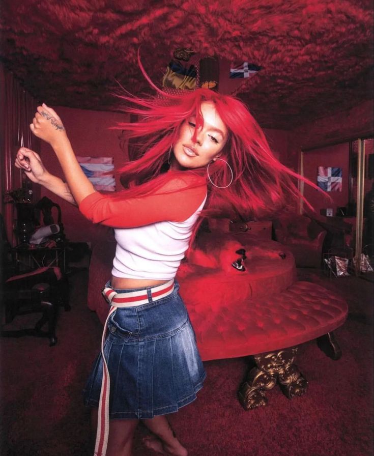 a woman with red hair standing in a room