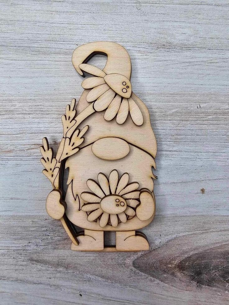 a wooden cutout of a gnome holding a flower