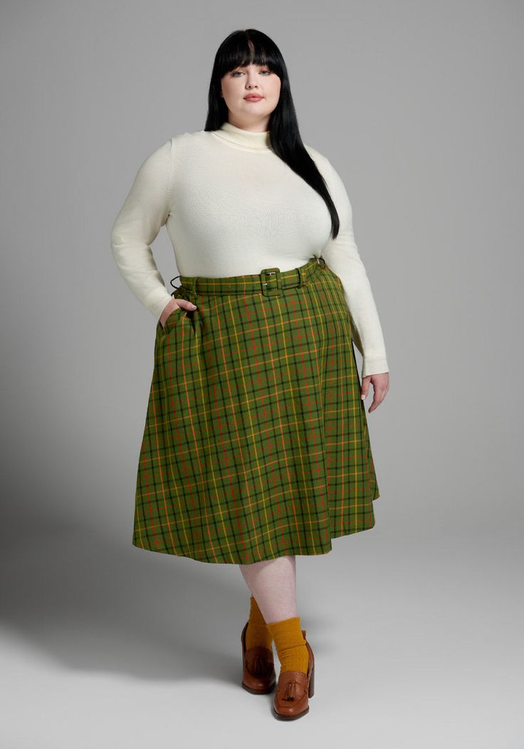 A darling new silhouette from our ModCloth namesake label, we bring you this swishy belted swing skirt ! Made from a viscose blend woven fabric, this 50’s-inspired A-line skirt boasts a matching and removable belt at the high-rise waistline, handy side pockets, and a retro-chic knee-length finish. Covered throughout in our exclusive green and mustard-hued plaid print that’s perfect for fall, this scholastic swing skirt looks great styled over warm tights and a cozy turtleneck, or paired with a t Retro Knee-length Winter Skirt, Winter Retro Knee-length Skirt, Retro Fall Skirted Skort, Retro A-line Winter Skirt, Plus Size Cottagecore Fashion, Holiday Party Pants, Plus Size Vintage Fashion, Warm Tights, Plus Size Vintage Clothing