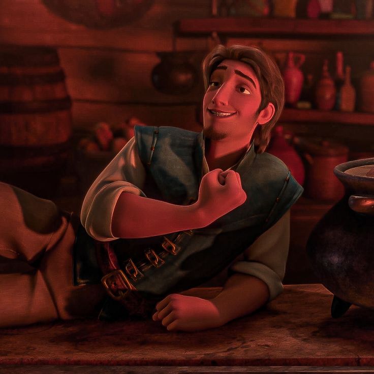 a man sitting on the floor in front of a pot and other pots, giving thumbs up