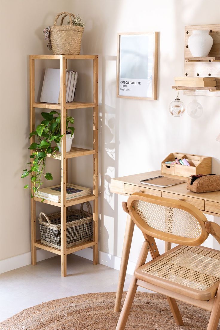 a wooden desk and chair in a small room with white walls, wood shelving and baskets on the shelves