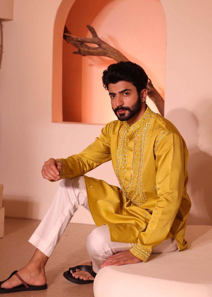 Introducing hasrat kurta with hand embroidery on hem & yoke consisting detailed thread, sequence, mirror and bead work with inside lining. Festival Cotton Silk Bandhgala With Dabka Work, Festival Bandhgala With Dabka Work In Cotton Silk, Traditional Drape Kurta With Dabka Work In Cotton Silk, Cotton Silk Kurta With Dabka Work In Traditional Drape, Designer Cotton Silk Bandhgala For Festivals, Eid Cotton Silk Bandhgala With Dabka Work, Festive Cotton Silk Bandhgala With Dabka Work, Traditional Raw Silk Kurta With Gota Work, Transitional Raw Silk Kurta With Chikankari Embroidery