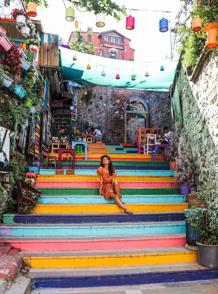 a woman sitting on top of colorful steps