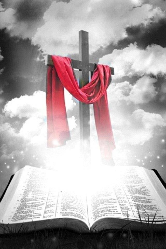 an open book with a cross and red cloth draped over it in front of a cloudy sky