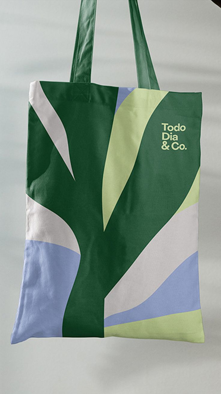 a tote bag hanging from the side of a wall with a tree on it