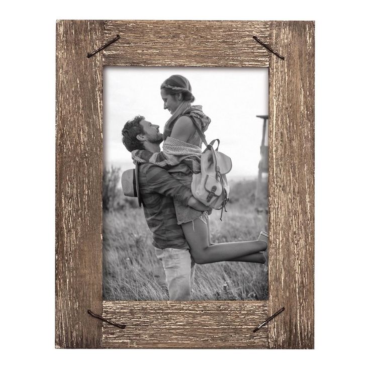 an old wooden frame with a man and woman kissing