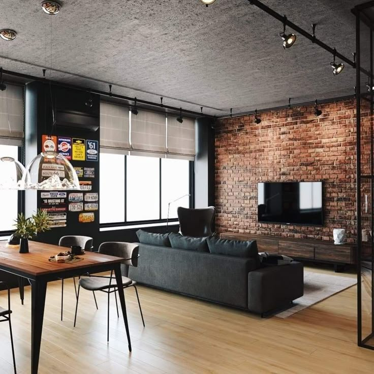 a living room filled with furniture and a flat screen tv mounted to a wall next to a window