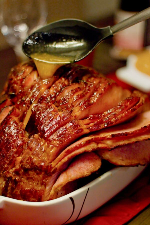 a spoon is pouring sauce on some meat