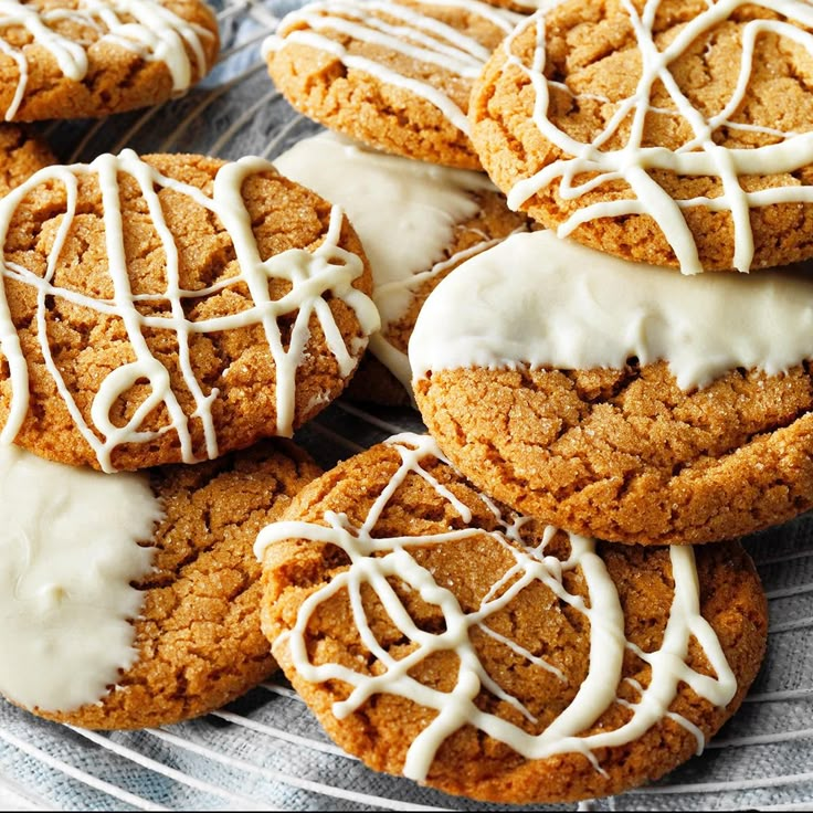 cookies with white icing are on a wire cooling rack, ready to be eaten