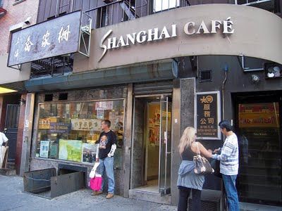 people are standing in front of a restaurant