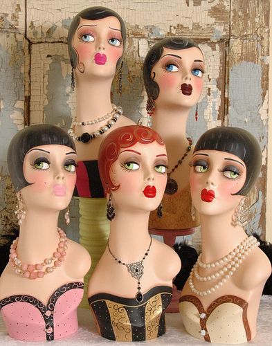 a group of mannequins with different colored hair