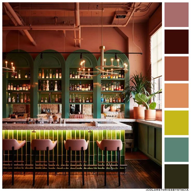 a bar with lots of bottles on the shelves and green chairs in front of it