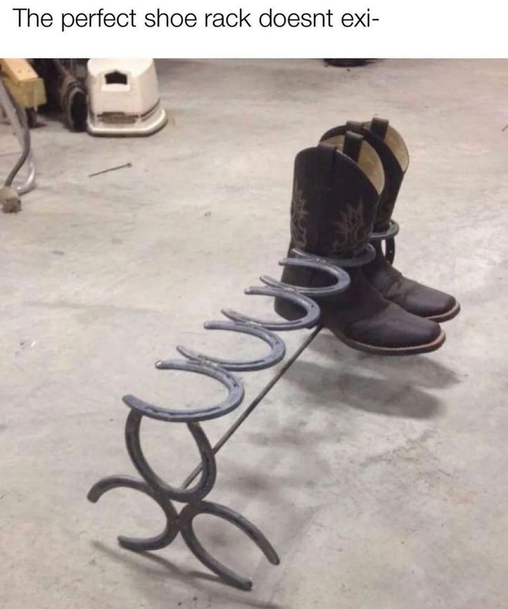 a pair of boots that are sitting on a rack with shoes hanging from it's sides