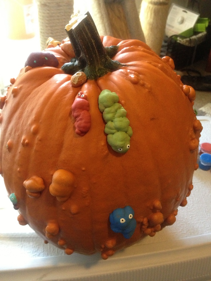 there is a very large pumpkin decorated with many things