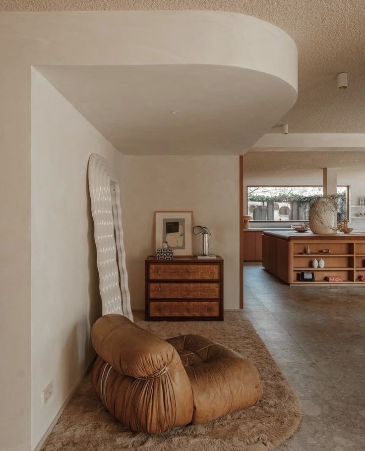 a living room filled with furniture and lots of windows