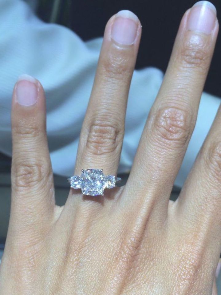 a woman's hand with a diamond ring on it