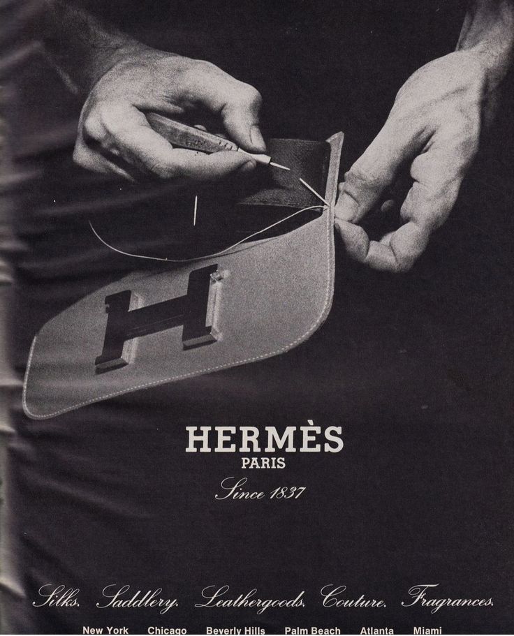 an advertisement for herme's paris in the 1970's, with two hands holding a pair of scissors