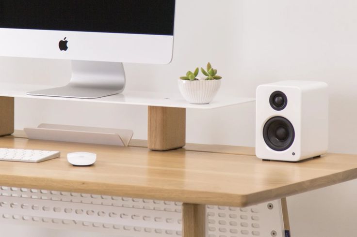 an apple computer sitting on top of a wooden desk