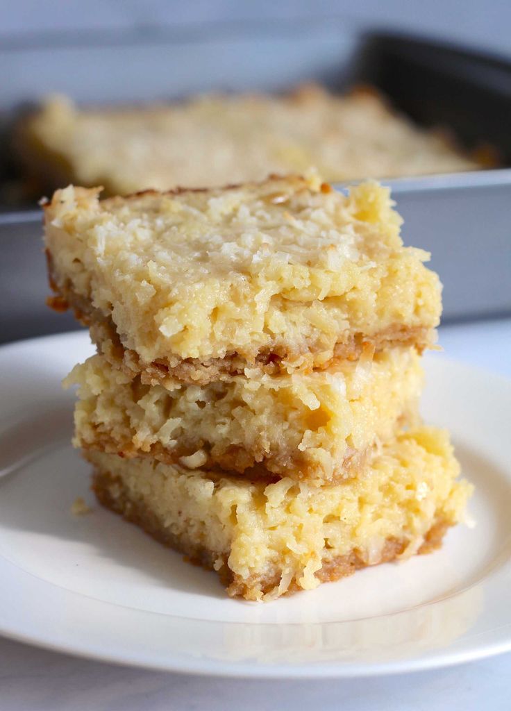 three pieces of cake sitting on top of a white plate next to a baking pan