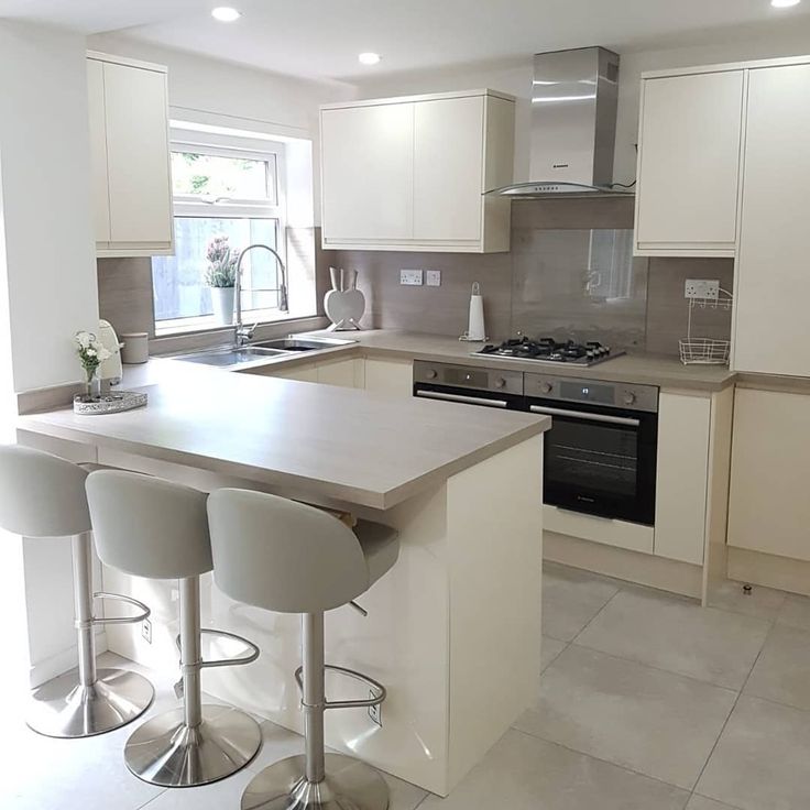 a kitchen with white cabinets and counter tops