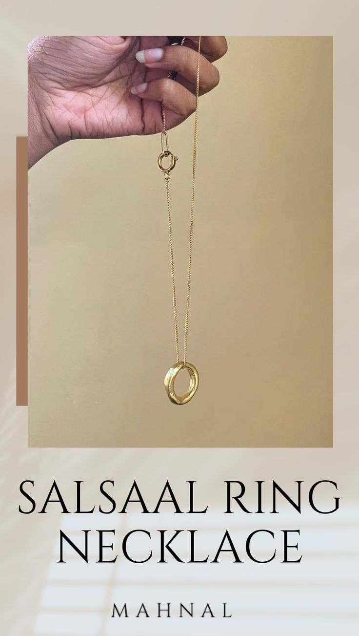 A Salsaal Major Ring sits as the centerpiece of this elegant necklace. Designed to look like an ancient treasure unearthed and found again.Sister style to the Salsaal Collection. Timeless Metal Open Ring Jewelry, Spiritual Open Ring Jewelry For Formal Occasions, Timeless Open Metal Ring, Gold Brass Ring Jewelry, Sterling Silver Jewelry With Ring Detail For Formal Occasion, Formal Sterling Silver Jewelry With Ring Detail, Yellow Gold Open Ring Jewelry In Brass, Unique 14k Gold Jewelry With Ring Detail, Heirloom Brass Open Ring Jewelry