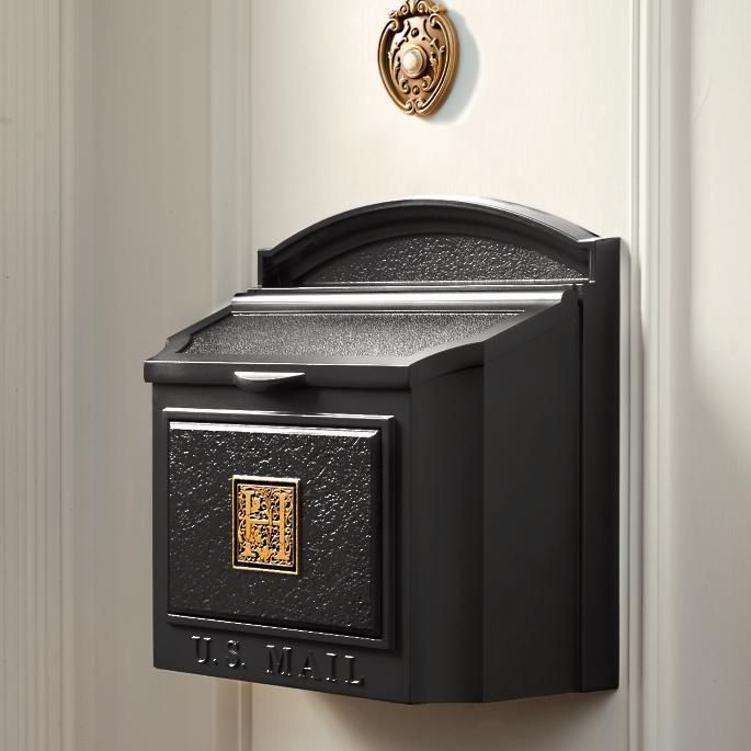 a black mailbox mounted to the side of a door