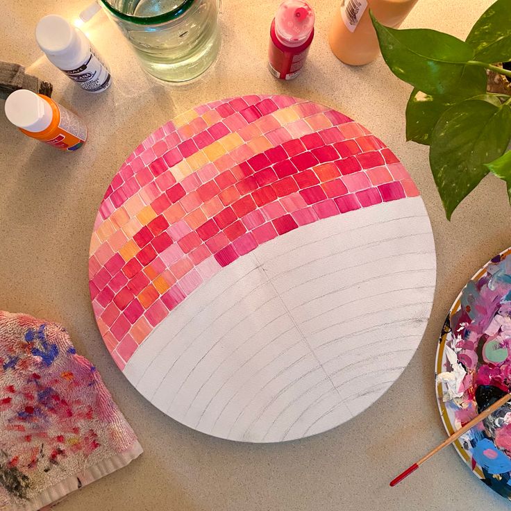 the table is covered with paint and other crafting supplies, such as paper plates