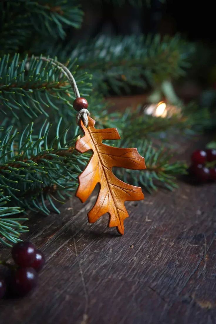 an oak leaf ornament hanging from a christmas tree