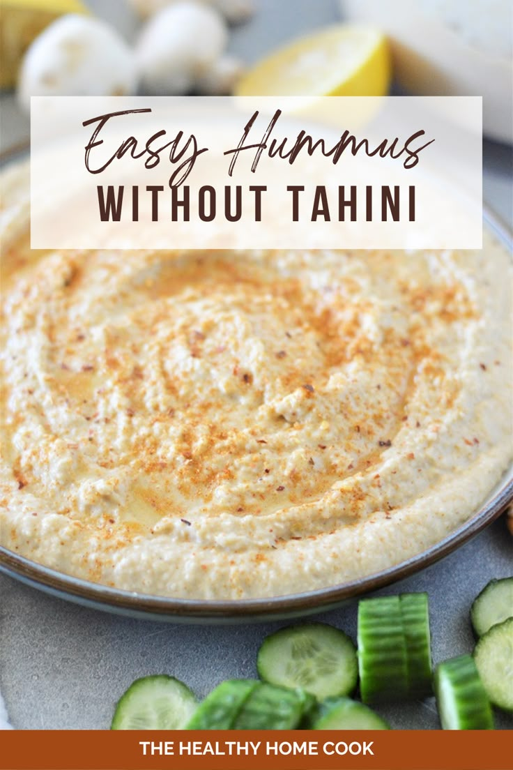 an easy hummus without tahitii on a plate with sliced cucumbers