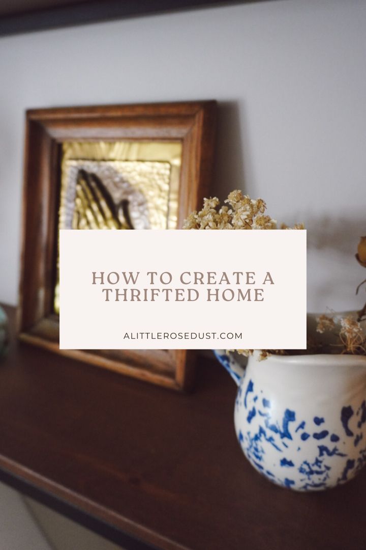 a wooden shelf topped with vases filled with flowers next to a framed photograph and text overlay how to create a thrifted home