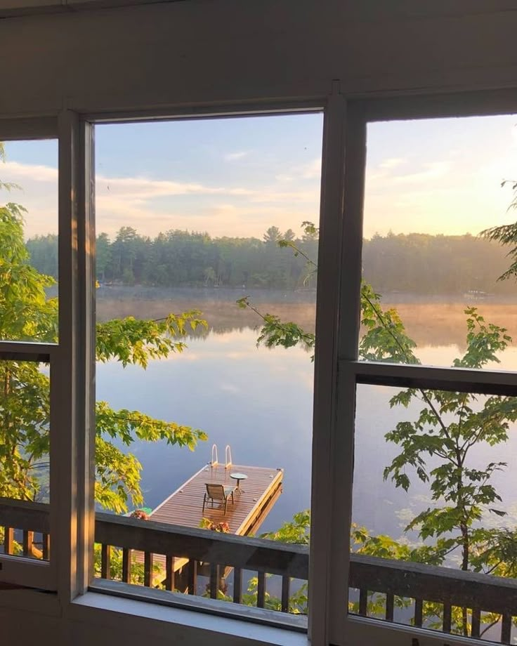 an open window with a view of a lake