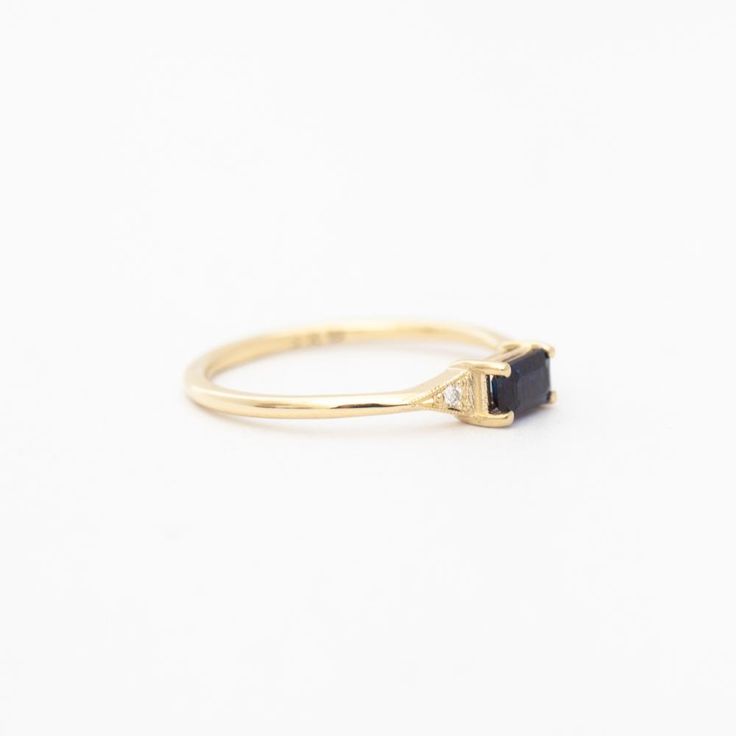 A azure blue sapphire set in Jennie Kwon's signature deco setting makes for a perfectly balanced piece that's deliciously dainty. Wear her as an alternative bridal ring—or on any finger, just because. Made in the U.S.A. 14 karat gold set with one 5 mm x 3 mm blue sapphire and two 1.2 mm diamonds. Timeless Emerald-cut Sapphire Promise Ring, Timeless Emerald Cut Sapphire Promise Ring, Elegant Ethical Sapphire Promise Ring, Timeless 14k Gold Sapphire Ring, Timeless Sapphire Ring For Gift, Timeless Sapphire Ring For Promise, Timeless Sapphire Ring As Gift, Timeless Sapphire Diamond Ring With Emerald Cut, Timeless Sapphire Promise Ring With Prong Setting